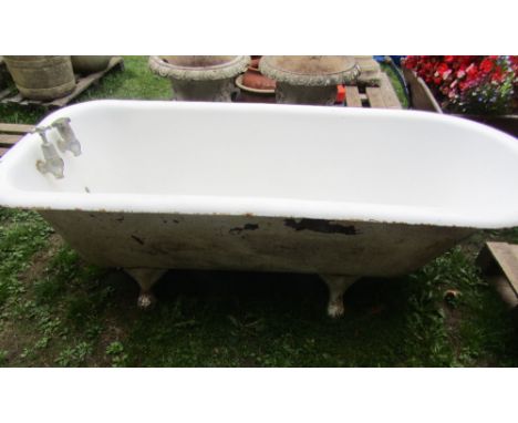A reclaimed cast iron and enamel roll top bath