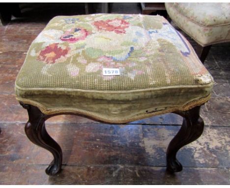 A small mid-19th century rosewood centre stool, raised on four carved and moulded cabriole supports, with hand worked tapestr