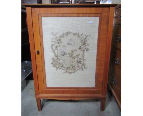 An Edwardian walnut, side/music cabinet, enclosed by a rectangular glazed panelled door with tapestry panel of a classical fe