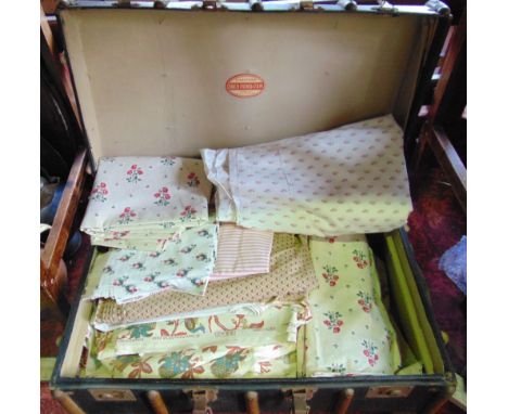A lathe bound leather travelling trunk fitted with a collection of various Laura Ashley fabric, and others