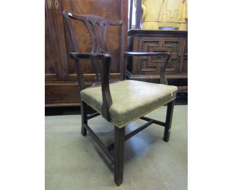 A pair of Georgian mahogany open armchairs in the Chippendale style, with gothic tracery vase shaped splats over upholstered 