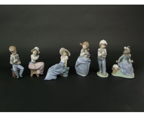 A collection of six Nao figure groups of children with their pets, a girl with a bird, etc