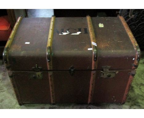 A vintage brown compressed fibre and timber lathe bound travelling trunk with brass fittings, stitched leather side carrying 