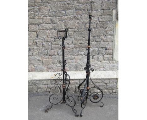 A late Victorian iron work floor standing telescopic oil lamp standard, partially sprung stem and scrolled supports with copp