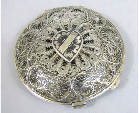 Persian/eastern white metal filigree work compact, the hinged lid enclosing a further enamel lid, decorated with a marine sce