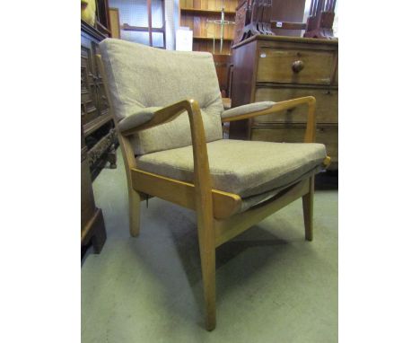 A pair of Parker Knoll style open armchairs with oatmeal ground upholstered seats and button backs within light beechwood fra