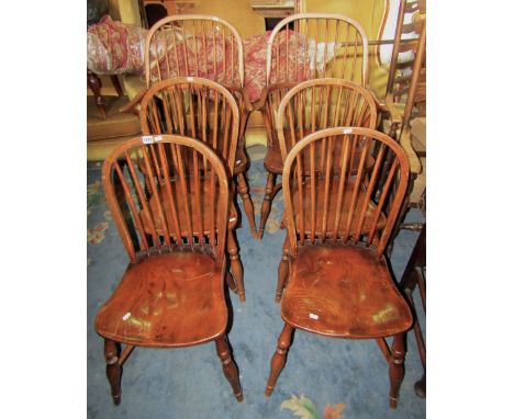 A set of six (4&2) good quality reproduction Windsor hoop and stick back dining chairs with saddle shaped seats raised on spl