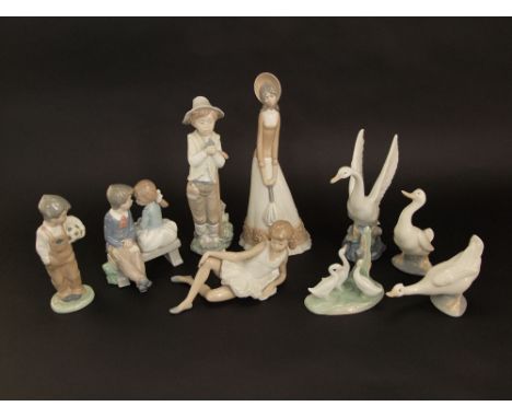 A collection of Nao figure groups including a reclining dancer, children on a bench, a boy holding a bird, etc, together with