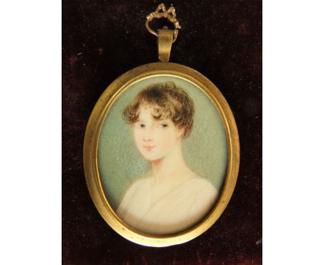 19th century school - Miniature bust portrait of a lady in a white dress, work on ivory, fitted into a gilt metal pendant, 6 