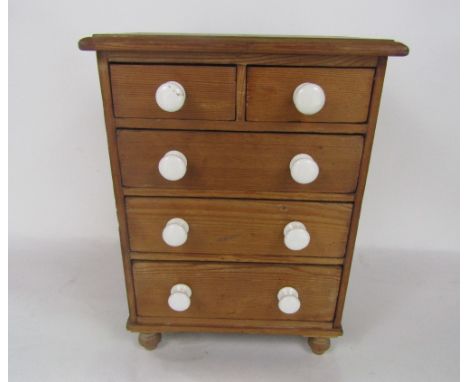 Late 19th century pine apprentice chest of drawers, with two short over three long drawers with ceramic handles and turned bu