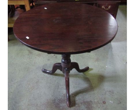 A Georgian mahogany snap top occasional table of circular form raised on a partially ring turned pillar and shaped tripod, 76