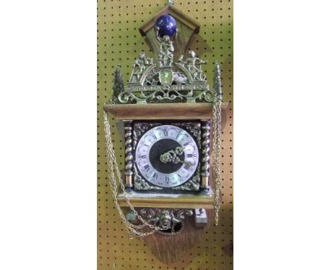 A Dutch figural wall clock mounted by Atlas and further cast figures of typical decoration, 63cm high