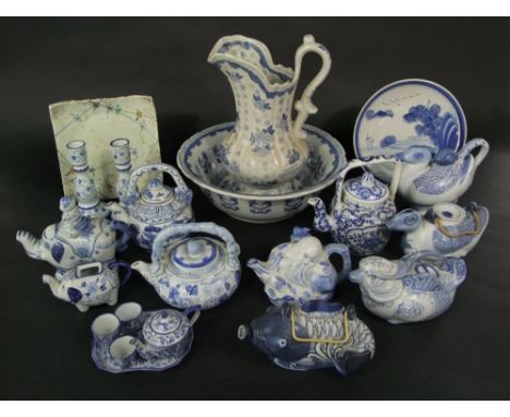 A quantity of mainly reproduction oriental blue and white ceramics including teapots in the form of ducks, fish, a bearded ma