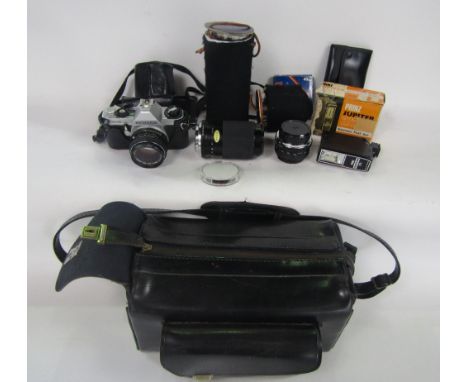 A leather photography bag with various camera equipment to include a Miranda 70-120mm macro lens, Pentax MG camera with 50mm 