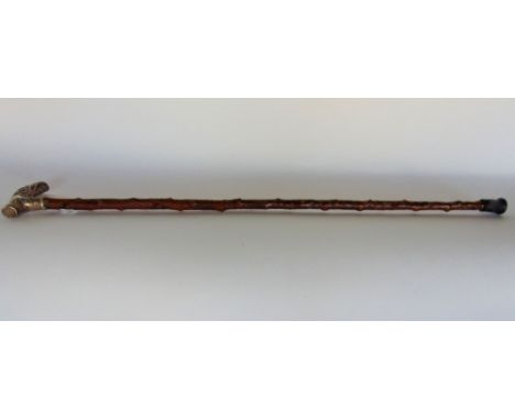 An interesting 19th century silver topped Sunday stick, with embossed white metal knop, with scrolled acanthus and further ca