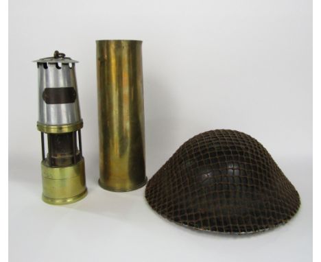 JH Nailer Ltd of Wigan, steel and brass miners lamp, together with a further trench art shell vase and military helmet (3)