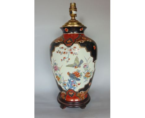 Chinese porcelain baluster vase lamp, decorated with polychrome panels of birds amidst foliage, upon a black ground, the vase