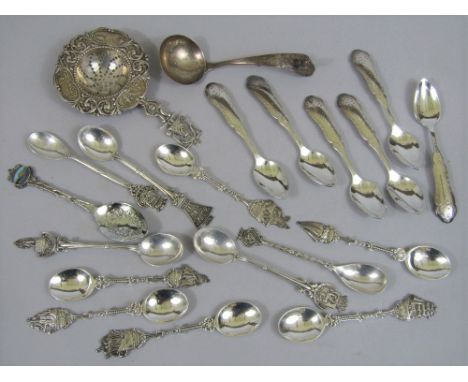 A mixed collection of continental white metal to include a Dutch caddy/sifter spoon and other further silver souvenir spoons,