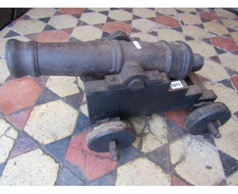 A good quality scale model replica cannon with cast iron barrel raised on a stepped wooden cart, the barrel 48 cm long