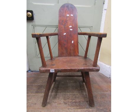 A primitive mixed woods (mainly elm and oak) elbow chair, with solid seat and tongue shaped back, raised on simple stick supp