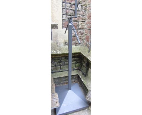 A contemporary grey painted light steel display stand with square cut column and flared base 