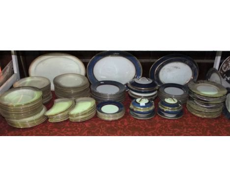 A quantity of Minton's dinner wares with gilt border decoration, retailed by Phillips of Oxford Street, including an oval mea