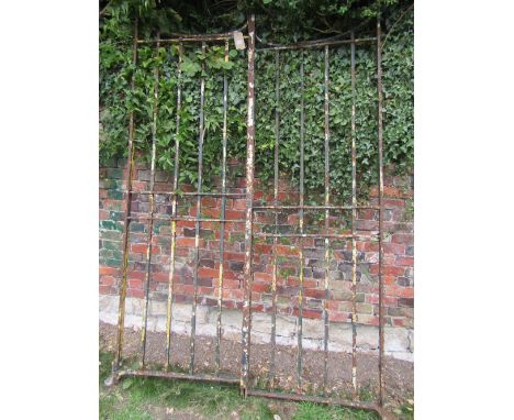 A pair of reclaimed good quality heavy iron work entrance gates with vertical open square cut rails and layers of weathered p