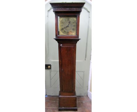An 18th century oak cottage longcase clock, the trunk with full length door, enclosing a 28cm square brass dial with applied 