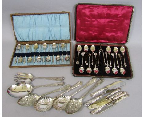 A leather case containing a suite of apostle/character spoons comprising twelve teaspoons and pair of sugar nips, each mounte