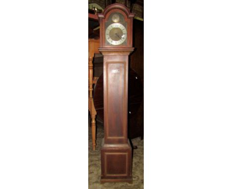 An oak cased grandmother clock with arched hood enclosing a brass dial with silvered chapter ring and three train movement, t