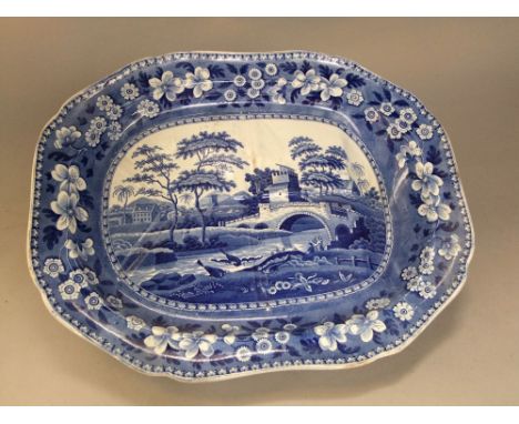 A large Spode blue and white printed meat dish in the Blue Tower pattern, together with gravy drainer and well, 53cm max
