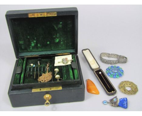 A fitted jewellery box with Bramah lock and key containing a quantity of costume jewellery to include a gold plated long guar