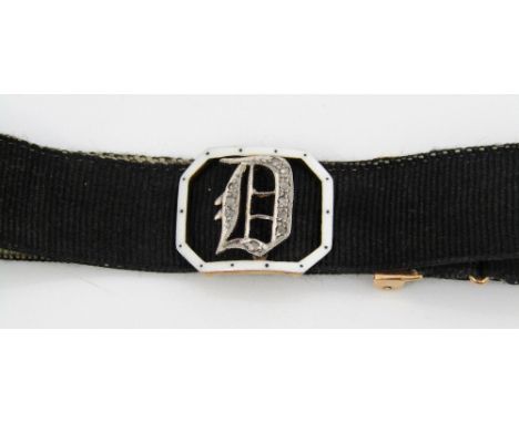 An initial D slider set with rose cut diamonds and white enamel border, on a moire ribbon bracelet with 15ct fastener
