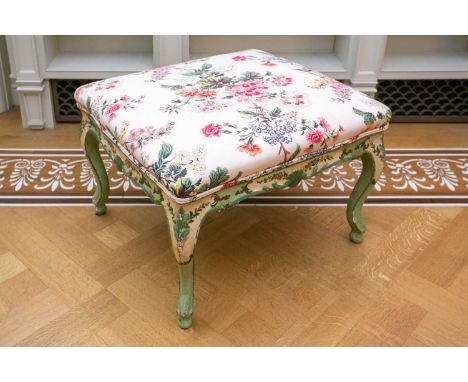 A green and floral painted George I style foot stool with chintz stuff over upholstery and shell carved frieze. 62cm long x 5