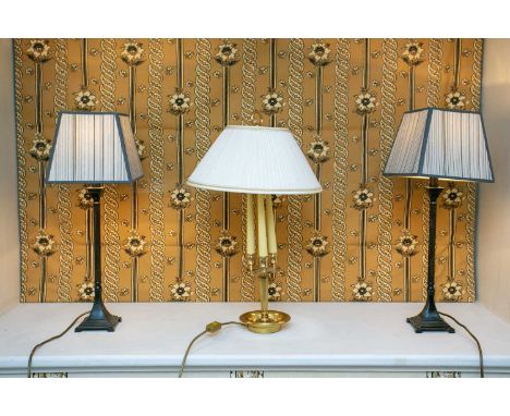 A pair of decorative painted metal classical column table lamps on square section bases, together with a brass three branch f