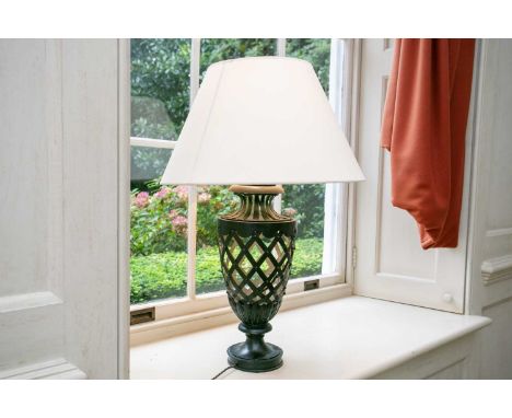 A contemporary wrought iron strapwork table lamp of urn form with cream shade. 78cm high.  Provenance: The contents of a Chel