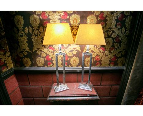 A pair of Art Deco style silver plated wicket form table lamps with cream angular shades. (2) 68cm high.  Provenance: The con