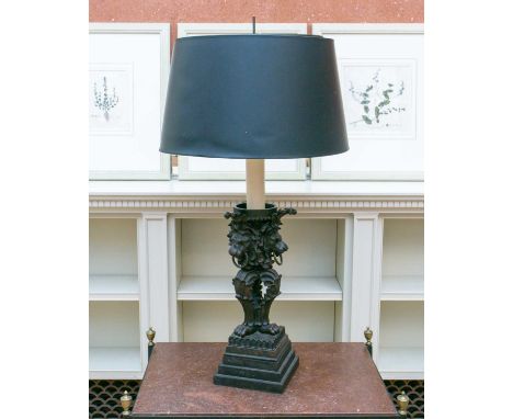 A 19th century style composition table lamp of bold lions mask monopodial form on a stepped square socle base with a black an