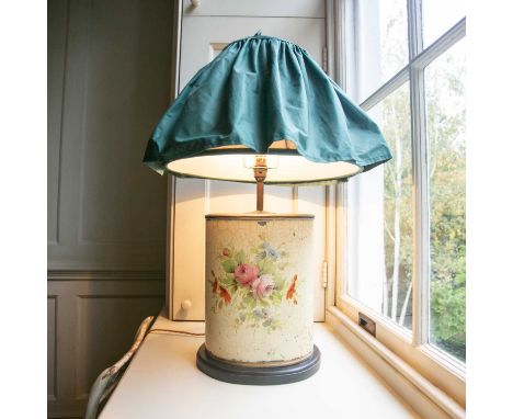 A decorative 20th century toleware lamp of oval section painted with cut blooms with ruffled green fabric shade. 74cm highPro
