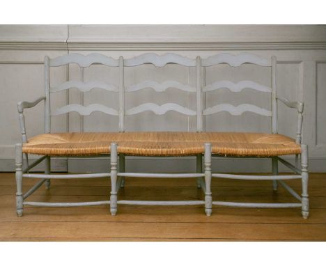 A sage painted 19th century style triple ladder back hall settle, with open arms, rush seat on spindle supports. 162cm long x