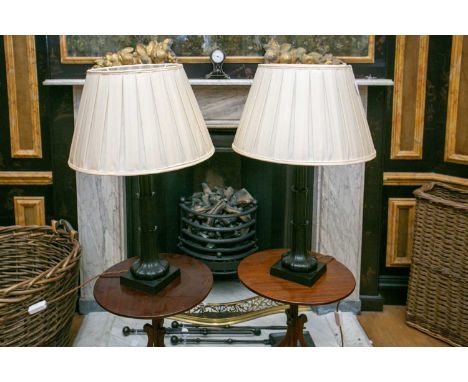 A pair of oxidised metal (possibly bronze) table lamps of sprouting lotus form on square socles, each with pleated shades. (2