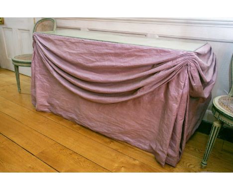 A contemporary glass topped side table in the style of Syrie Maugham with lilac swagged fabric valence, the interior fitted w