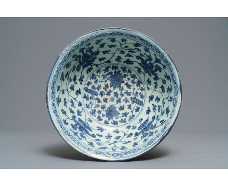 A Chinese blue and white 'peony scroll' bowl, Ming ----- Dia.: 33,5 cm - H.: 13,5 cm  Condition: (UV checked)- Generally in g
