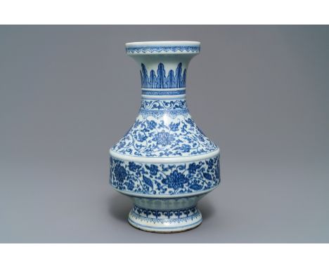 A Chinese blue and white flower scroll vase, Qianlong: H.: 34,5 cm  -----  Condition reports and high resolution pictures are