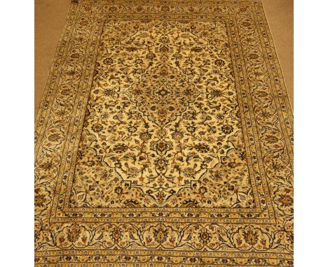 Fine Persian Kashan rug carpet, ivory ground with blue detail, trailing foliage and stylised flower heads, central medallion,