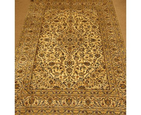 Fine Persian Kashan rug carpet, ivory ground with blue detail, trailing foliage and stylised flower heads, central medallion,