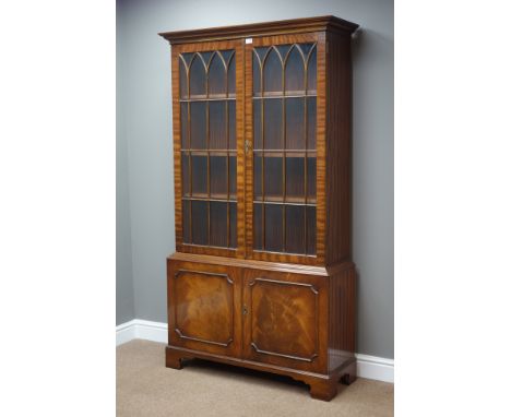 Reproduction mahogany bookcase on cupboard, three adjustable shelves, on bracket feet, W101cm, H185cm, D34cm