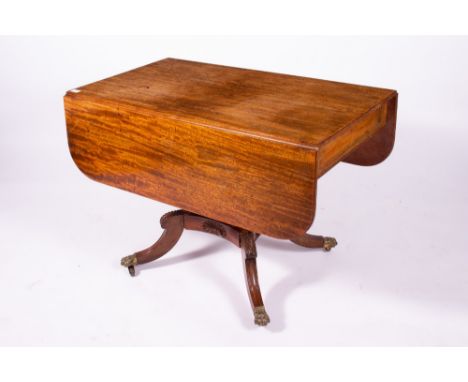 A 19TH CENTURY MAHOGANY DROP LEAF DINING TABLE with frieze drawer to one end, waisted column support and four sabre legs term