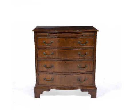 A GEORGIAN STYLE MAHOGANY SERPENTINE CHEST  with a brushing slide over four long drawers, and standing on bracket feet, 71.5c