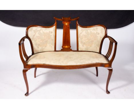 AN EDWARDIAN ART NOUVEAU STYLE MAHOGANY SATINWOOD AND MOTHER OF PEARL INLAID SUITE to include a settee, an armchair and two s